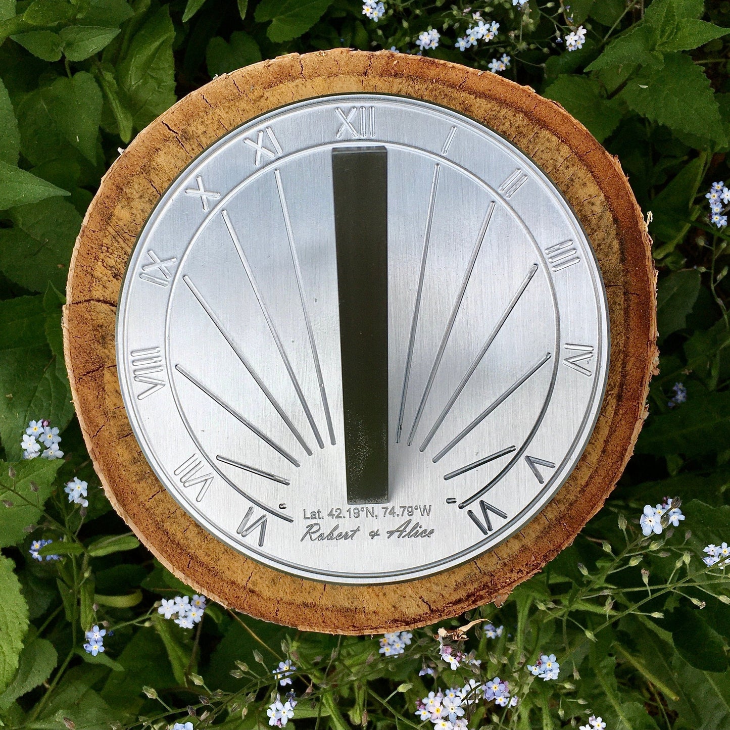 Sundial for garden displayed on flowers with a sundial compass engrave on it.