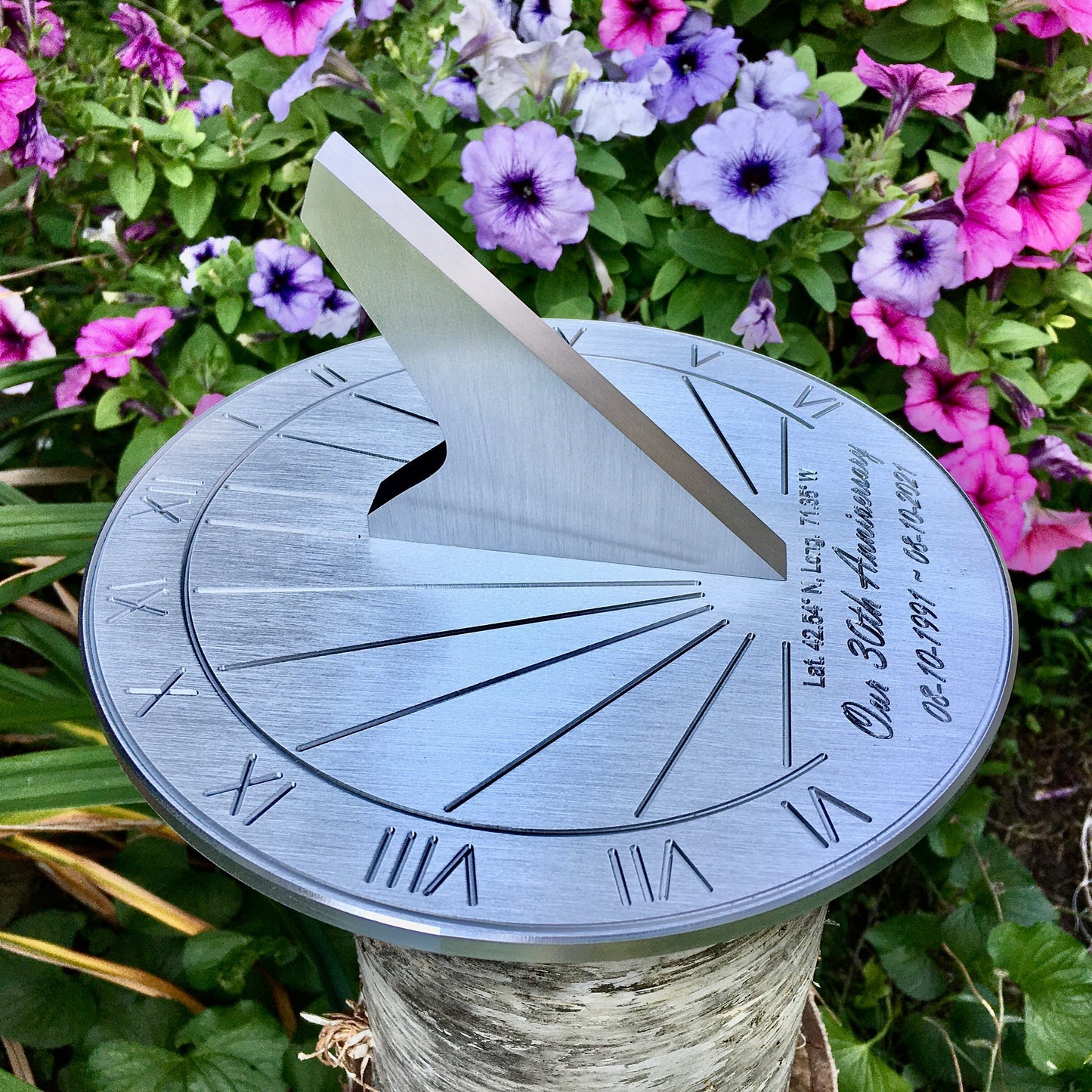 Pearl wedding anniversary gifts sundial in flower garden, celebrating 30 year anniversary of couple