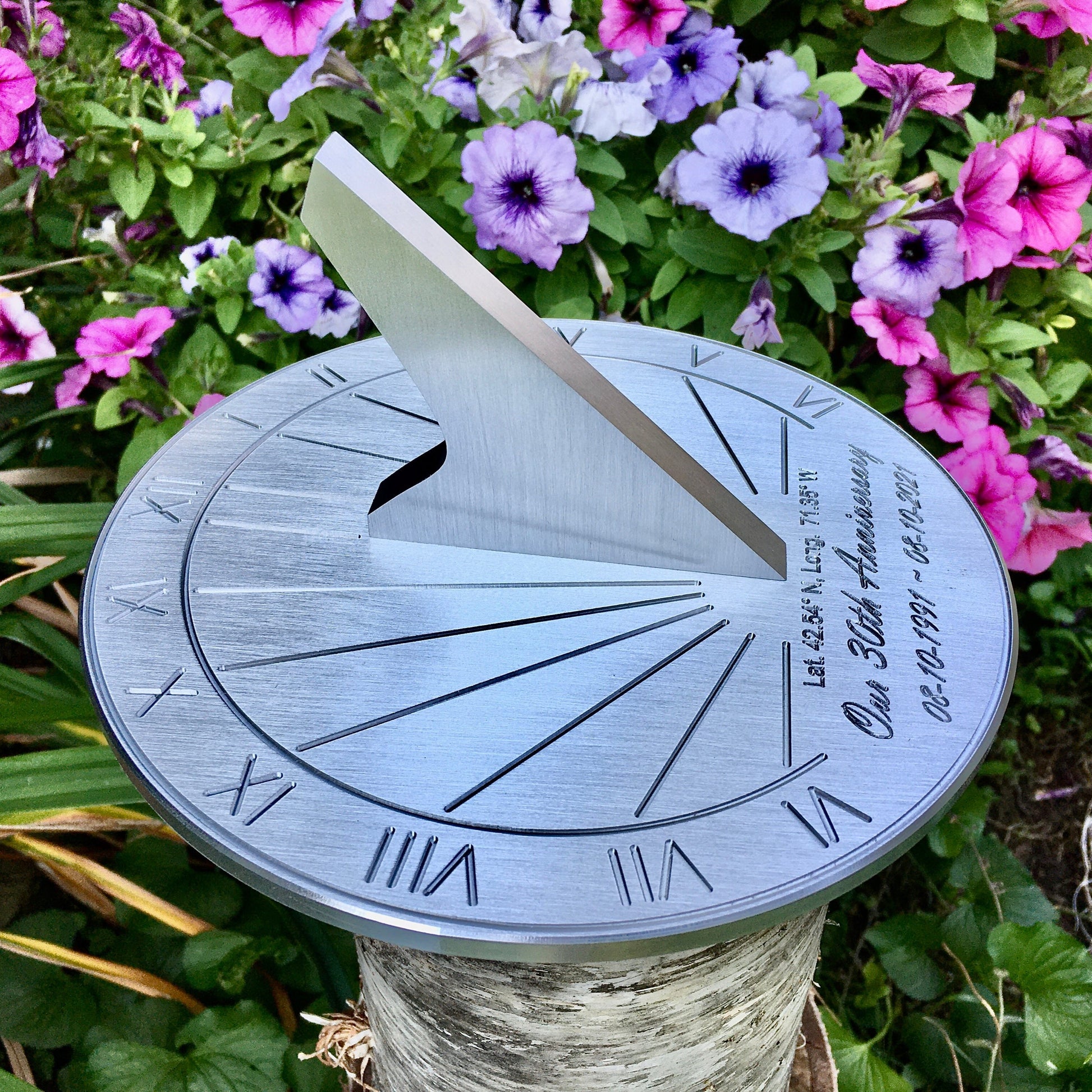 Pearl wedding anniversary gifts sundial in flower garden, celebrating 30 year anniversary of couple 