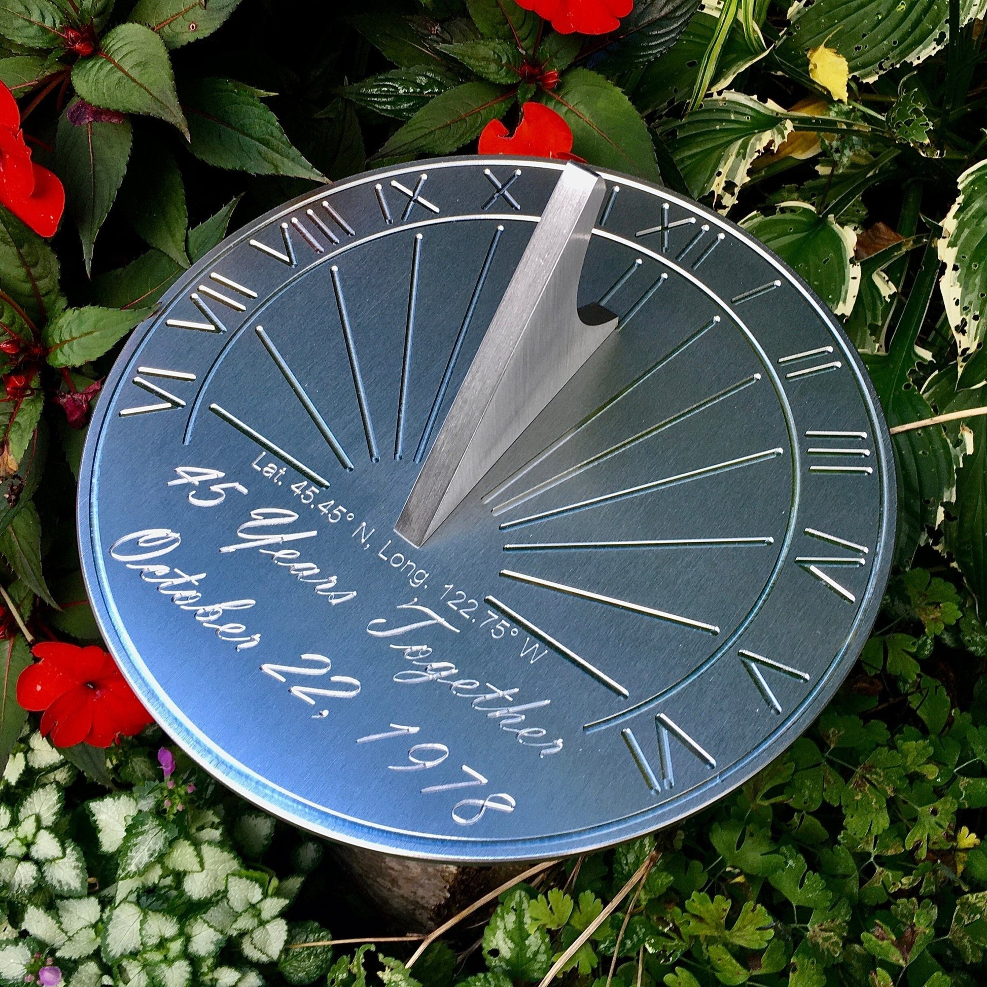 Blue sapphire anniversary gifts sundial displayed in garden celebrating a happy 45th wedding anniversary. 