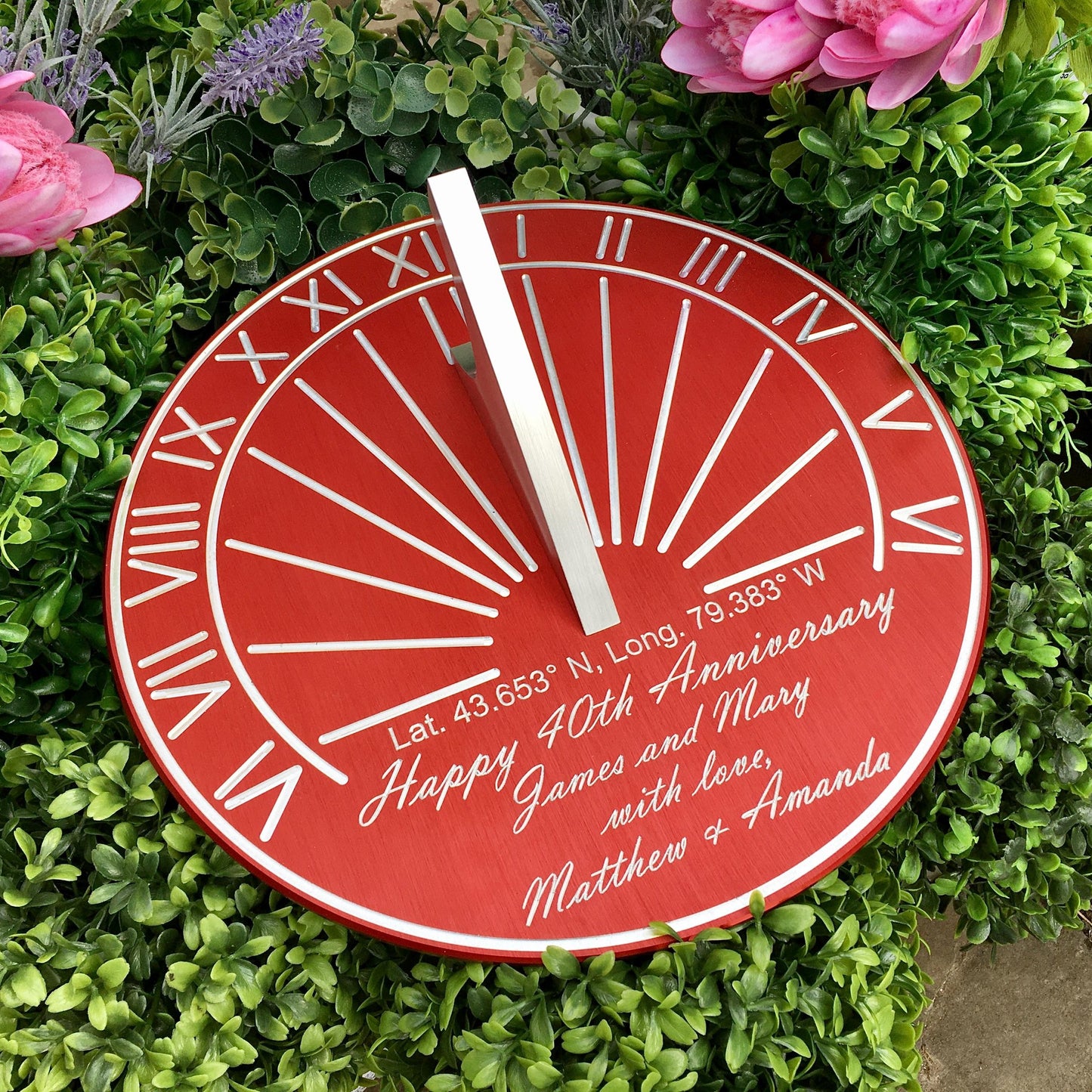 Ruby wedding gift ideas sundial shown on green plants in garden, the perfect ruby wedding gift for my husband. 