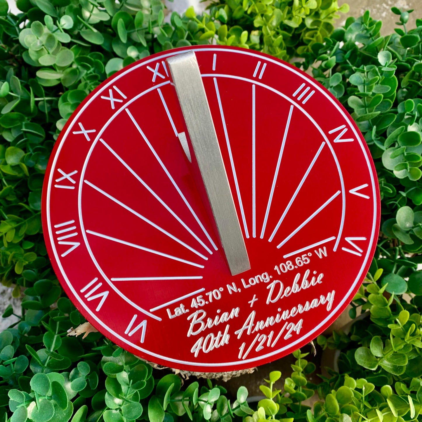 Ruby wedding gifts for wife displayed in garden, custom engraved for ruby wedding anniversary. 