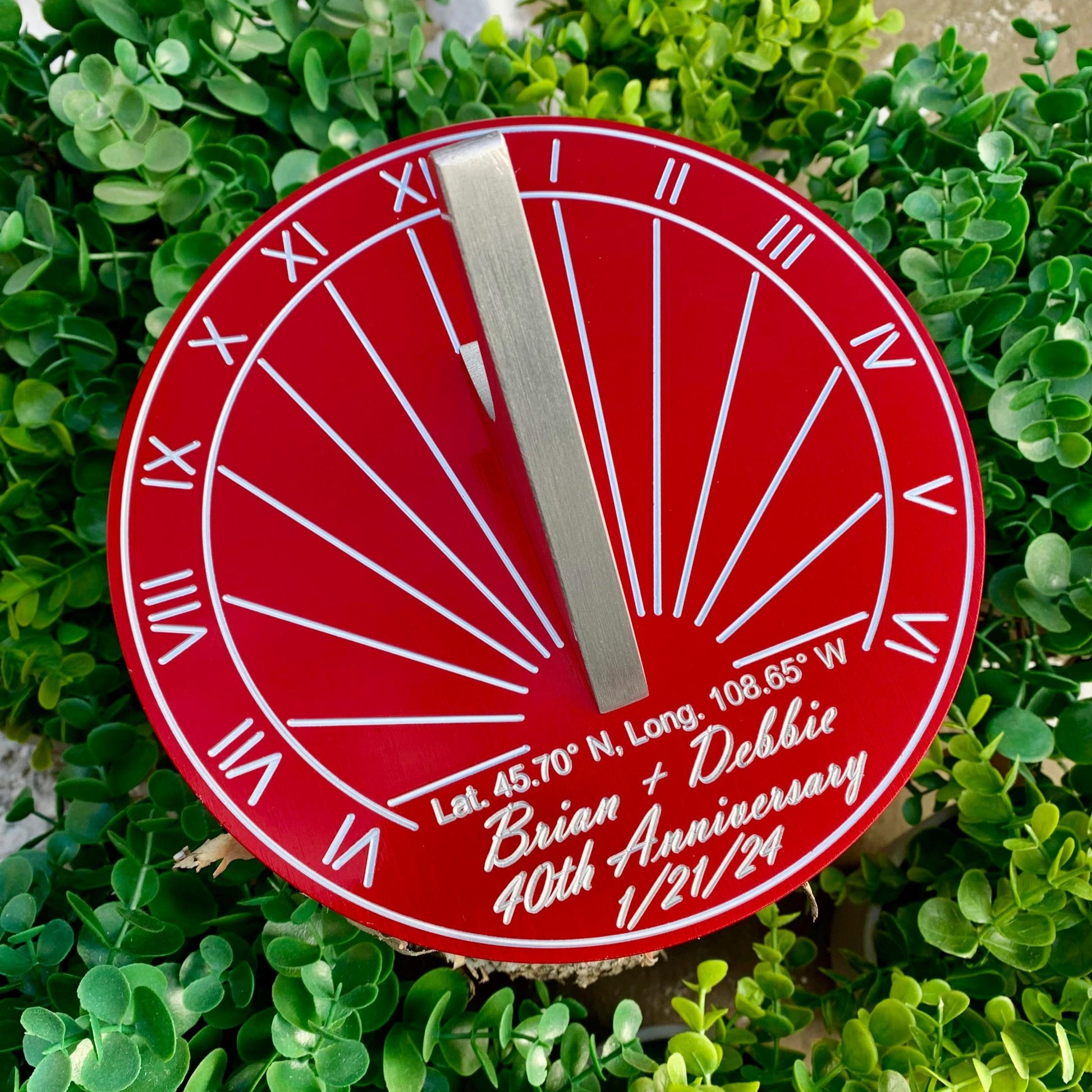 Ruby wedding gifts for wife displayed in garden, custom engraved for ruby wedding anniversary. 