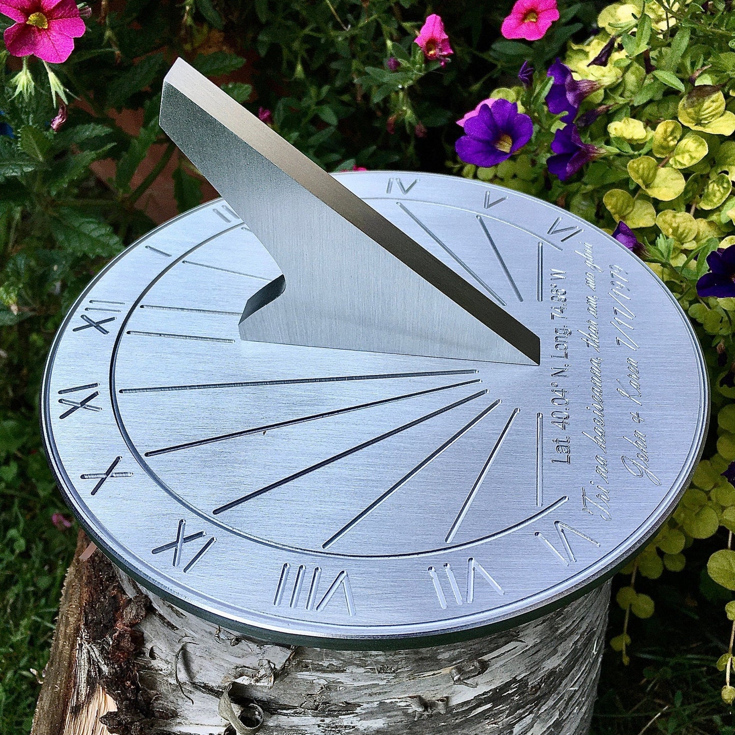 Ruby wedding gift ideas sundial shown on green plants in garden, the perfect ruby wedding gift for my husband. 