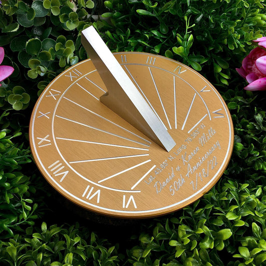 Wedding anniversary golden sundial in garden, beside flowers, displayed as a 50th wedding anniversary garden gifts sundial. 